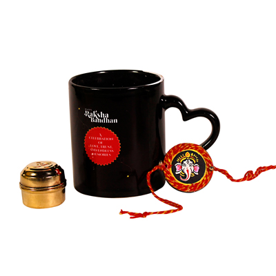 Heart handled coffee mug, Ganesh rakhi, and abrass tin with roli chawal